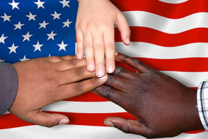 hands united over an american flag