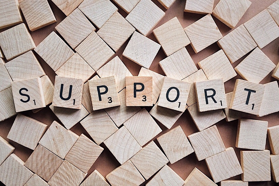 Scrabble tiles spell "support"